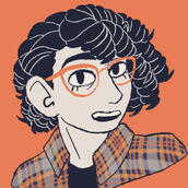 a picture of a curly haired person wearing an orange overshirt, her hair is blue and she is wearing orange glasses.